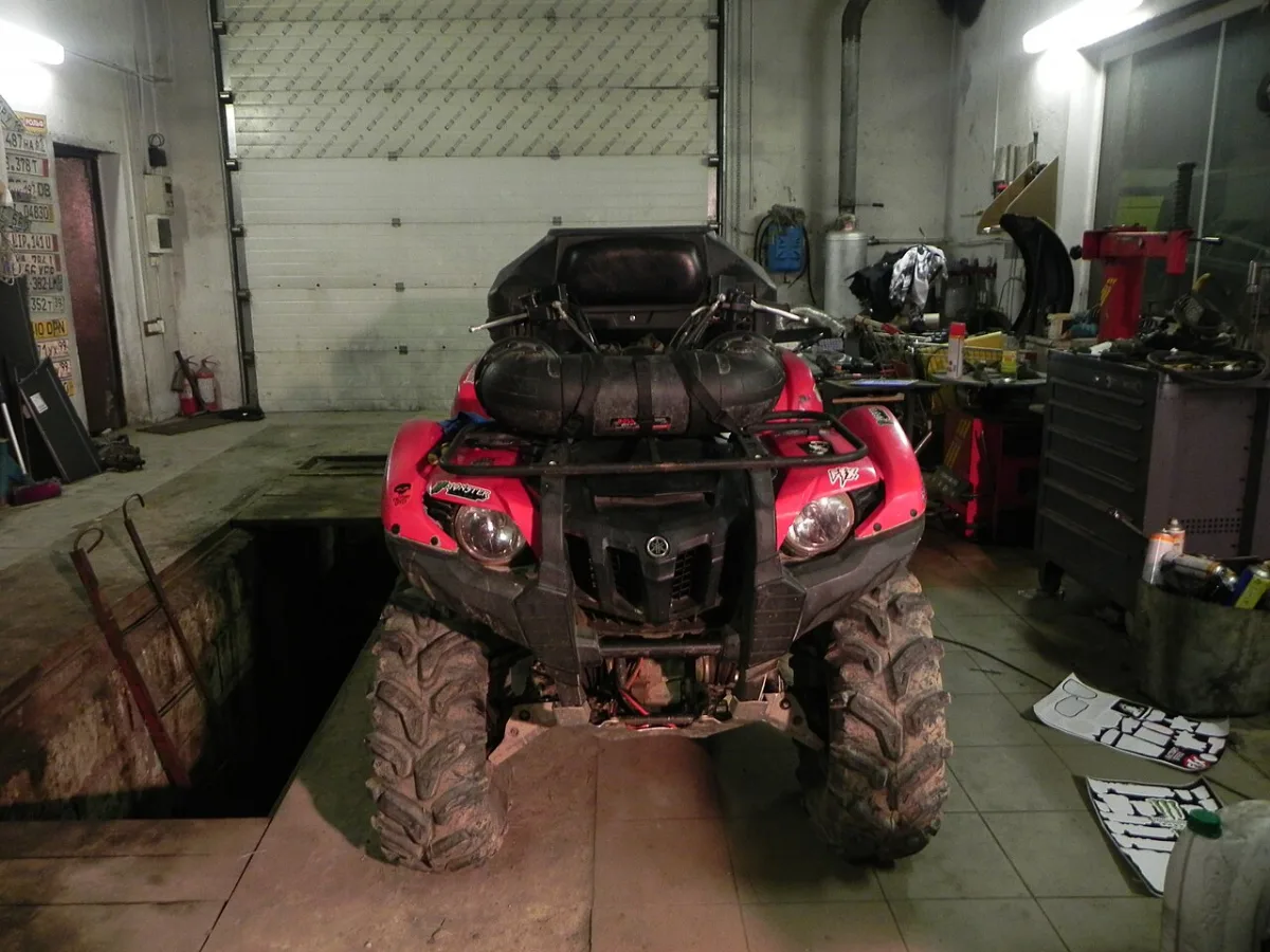 Yamaha Grizzly four-wheel ATV inside a workshop