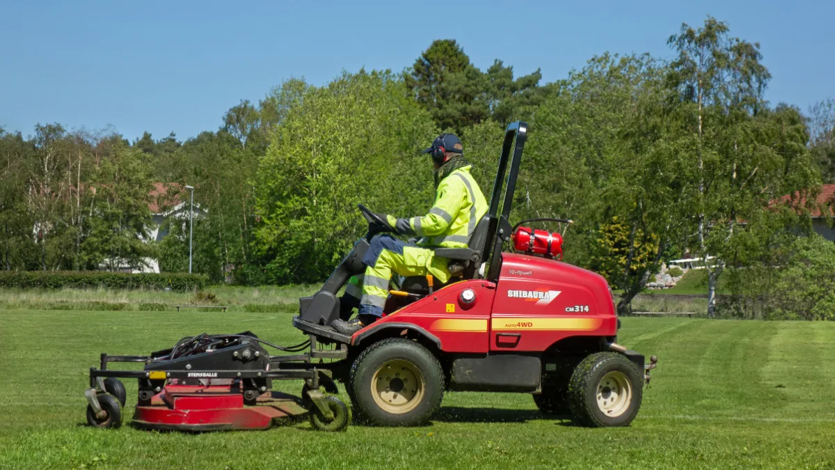 Riding mower on a grass field