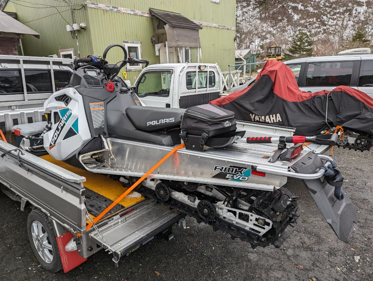 Snowmobile secured on a truck for transport